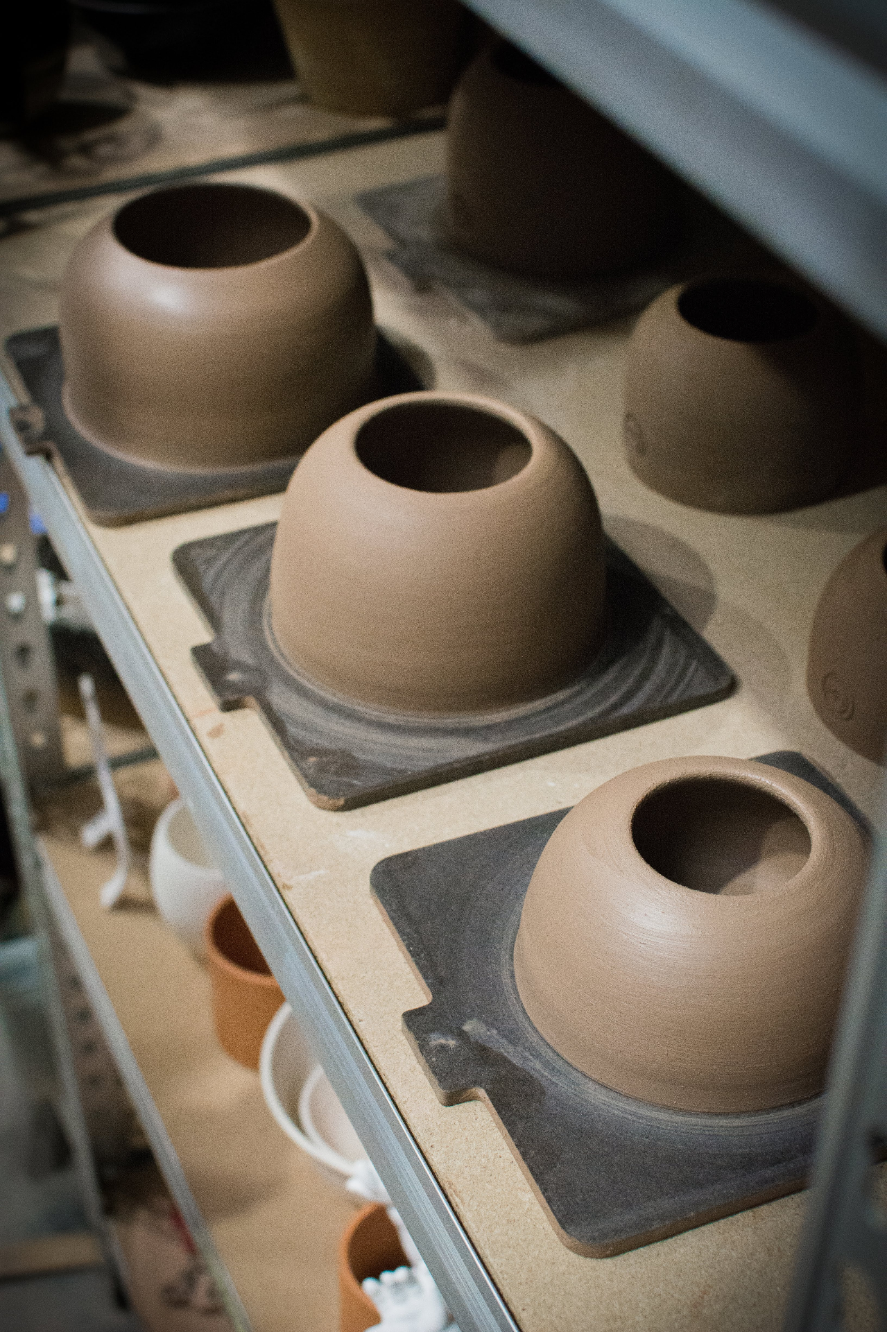 Handmade ceramic vases on a studio shelf — Muds Ceramics floral vase rentals, Napa Valley